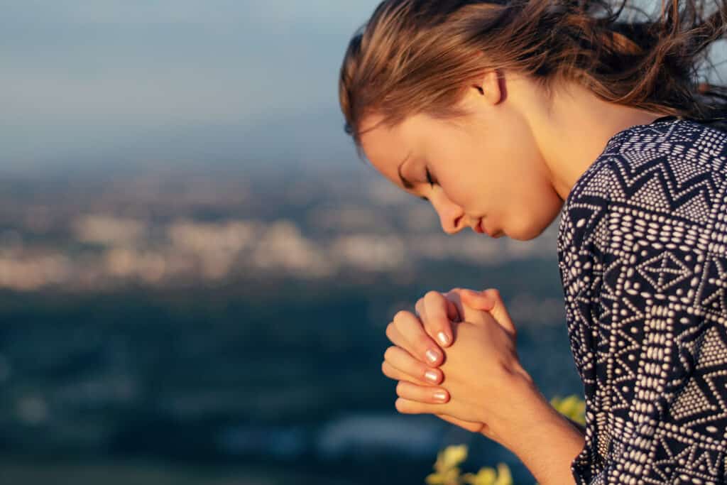 A young woman is praying.