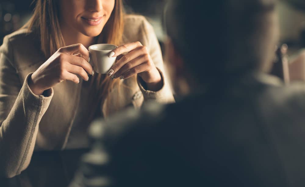 A couple is having coffee together at a cafe.